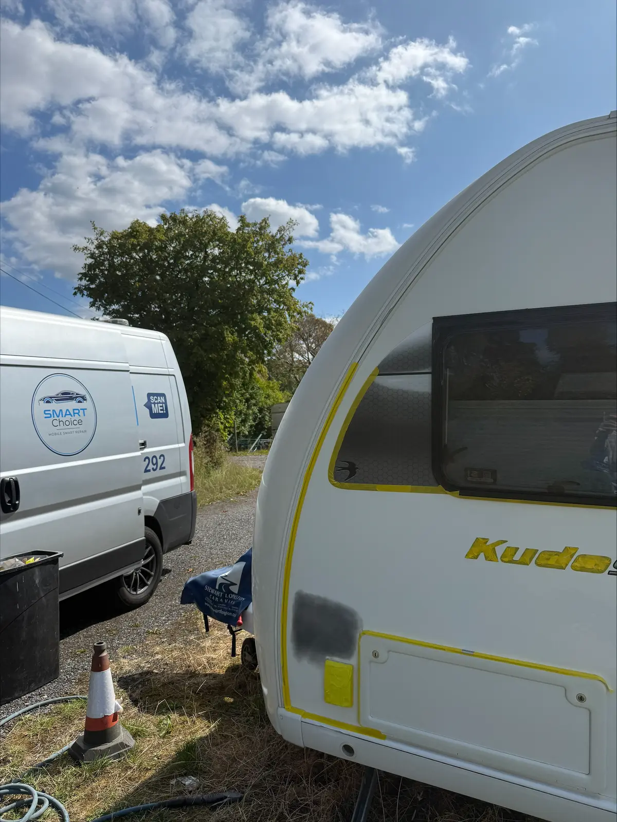 SMART Choice van parked beside a caravan being repaired on site